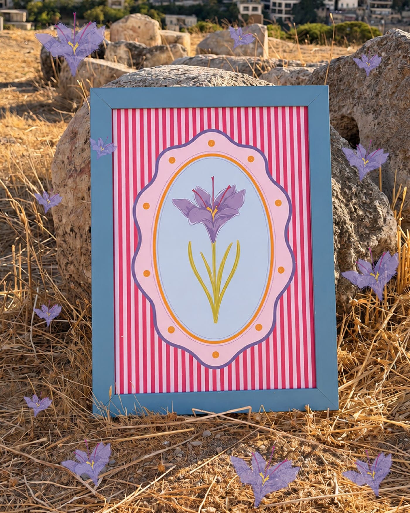 Iris print in a blue frame leaning on a rock among dry grass