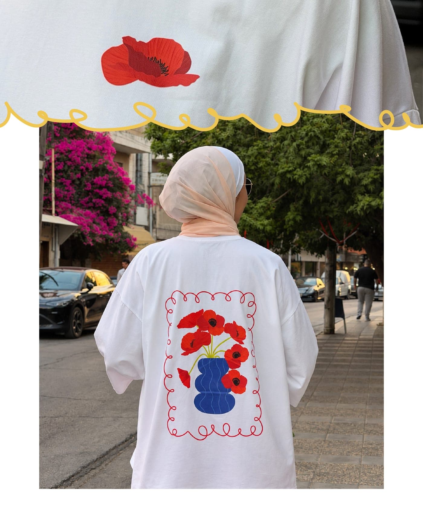 Back of a white oversized tee printed with the Dahnon poppies, worn on a street in Amman
