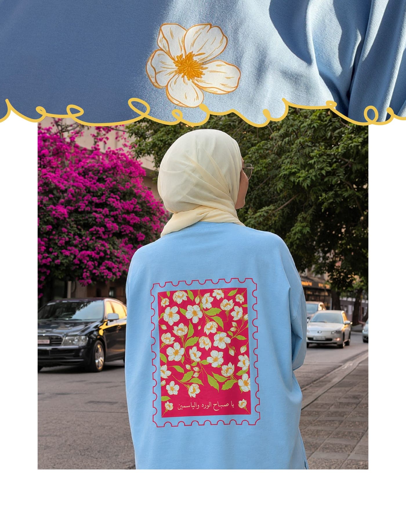 Back of a baby blue oversized tee printed with the Jasmine stamp, worn on a street in Amman